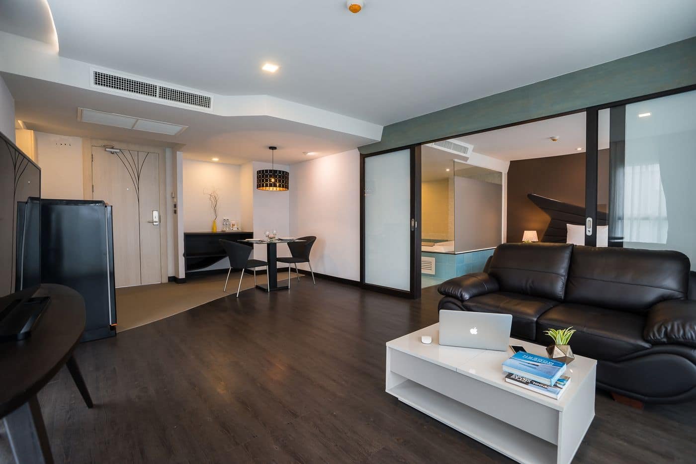 Suite living area with sofa and dining table at Blue Boat, Pattaya