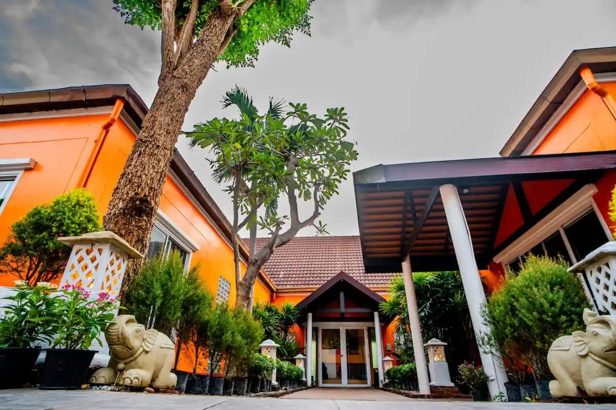 Entrance courtyard with trees at Magnitude Pool Villas