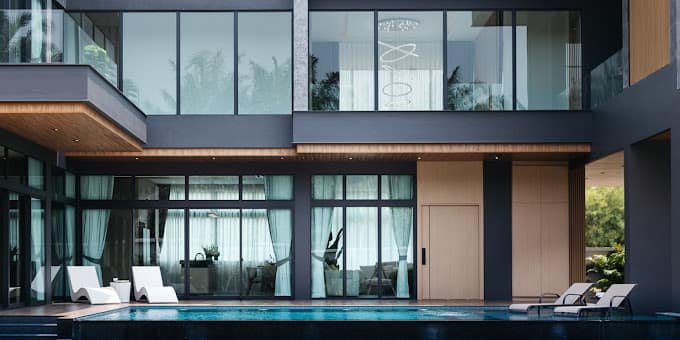 Pool and glass-fronted living spaces at The Sylva Luxury Pool Villa
