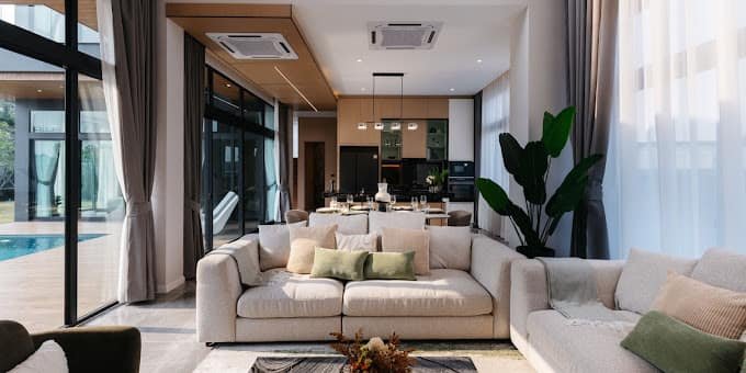 Open-plan living room with a sectional sofa at The Sylva Luxury Pool Villa