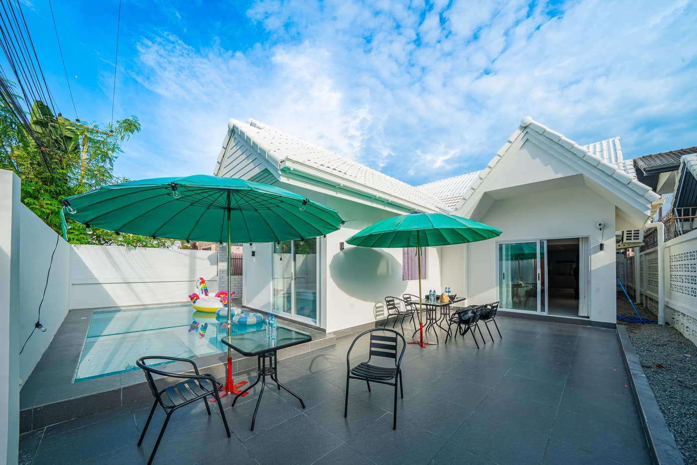 Private pool with umbrellas and loungers at Wonderland Villas, Pattaya